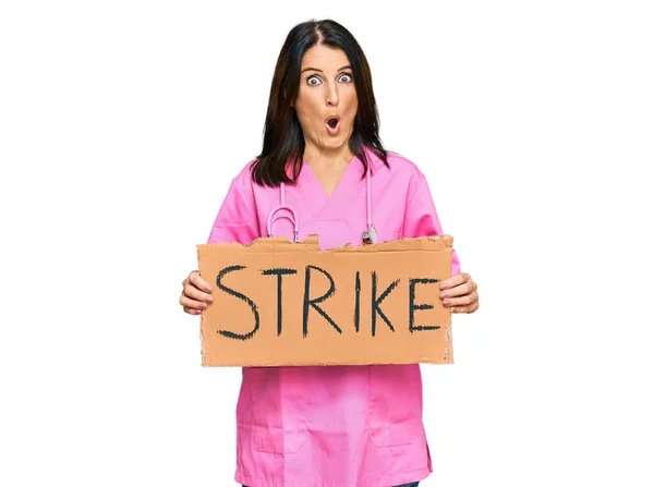 Middle Age Brunette Doctor Woman Holding Strike Banner Cardboard Scared — Stock Photo, Image
