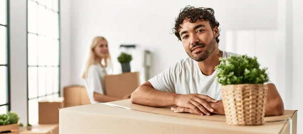 Young Man Smiling Happy Leaning Cardboard New Home — Stock Photo, Image