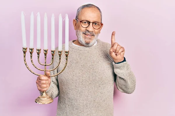 Handsome Senior Man Beard Holding Menorah Hanukkah Jewish Candle Smiling — Stock Photo, Image