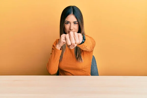 Young Hispanic Woman Wearing Casual Clothes Sitting Table Punching Fist — Stock Photo, Image