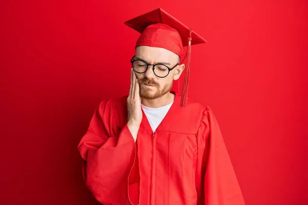 Young Redhead Man Wearing Red Graduation Cap Ceremony Robe Touching — Stock Photo, Image