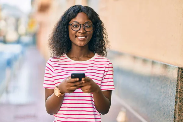 Mladý Africký Americký Dívka Usměvavý Šťastný Pomocí Smartphone Městě — Stock fotografie