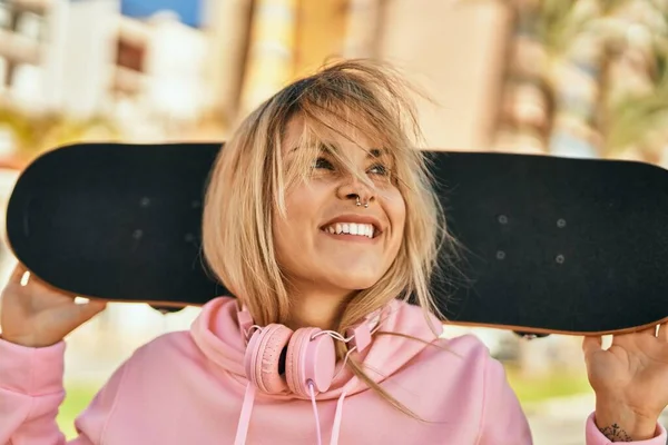 Joven Chica Rubia Patinadora Sonriendo Feliz Sosteniendo Patín Ciudad —  Fotos de Stock