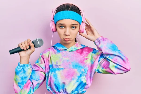 Joven Morena Cantando Canción Usando Micrófono Usando Ropa Deportiva Deprimida —  Fotos de Stock