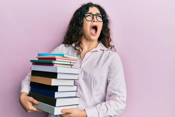 Young Brunette Woman Curly Hair Holding Pile Books Angry Mad — Stock Photo, Image