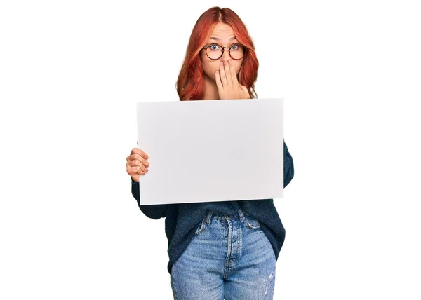 Young Redhead Woman Holding Blank Empty Banner Covering Mouth Hand — Stock Photo, Image