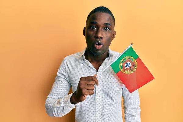 Mladý Africký Američan Drží Portugalskou Vlajku Vyděšený Ohromený Otevřenými Ústy — Stock fotografie