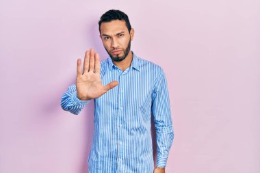 Sakallı, sıradan mavi gömlekli İspanyol bir adam avucunun içi gibi şarkı söylemeyi kesiyor. Yüzünde olumsuz ve ciddi bir jest olan uyarı ifadesi. 