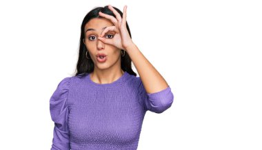 Günlük kıyafetler giyen genç İspanyol kız şaşırmış yüz ifadesiyle şok olmuş, parmaklarından bakan gözler. İnançsız ifade. 