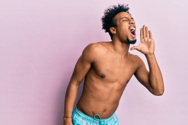 Sakallı, mayo giymiş, elleri ağızda bağırıp çağıran Afrikalı genç bir Amerikalı. iletişim konsepti. 