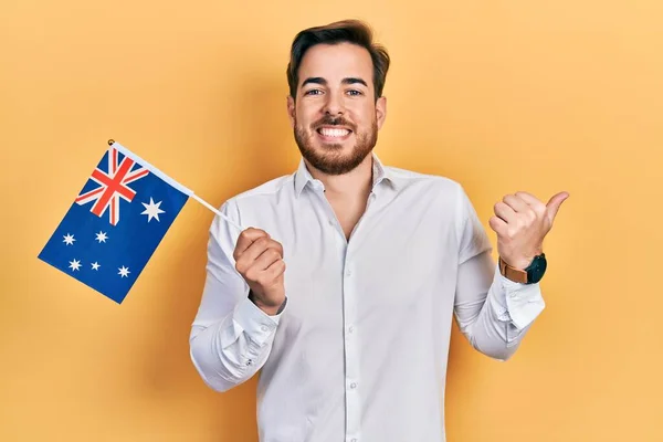 Handsome Caucasian Man Beard Holding Austria Flag Pointing Thumb Side — Stock Photo, Image