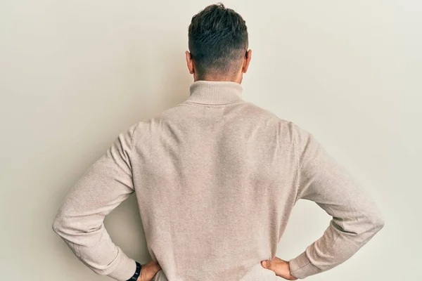 Hispanic Young Man Wearing Casual Turtleneck Sweater Standing Backwards Looking — Stock Photo, Image