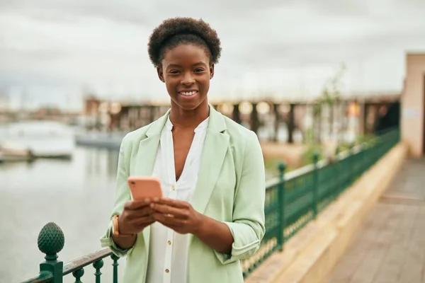 Joven Mujer Negocios Afroamericana Sonriendo Feliz Usando Teléfono Inteligente Ciudad —  Fotos de Stock