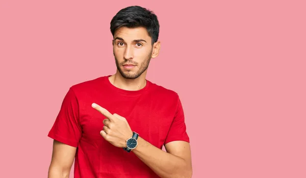 Joven Hombre Guapo Con Camiseta Roja Casual Señalando Con Dedo —  Fotos de Stock