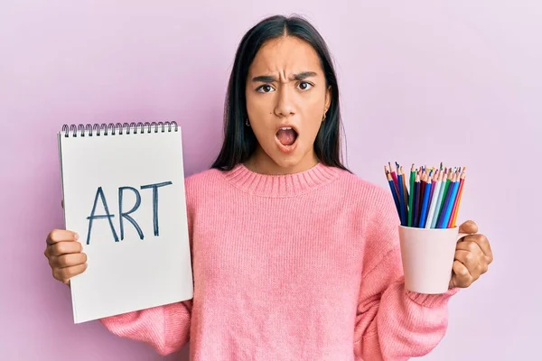 Young Asian Woman Holding Art Notebook Colored Pencils Shock Face — Stock Photo, Image
