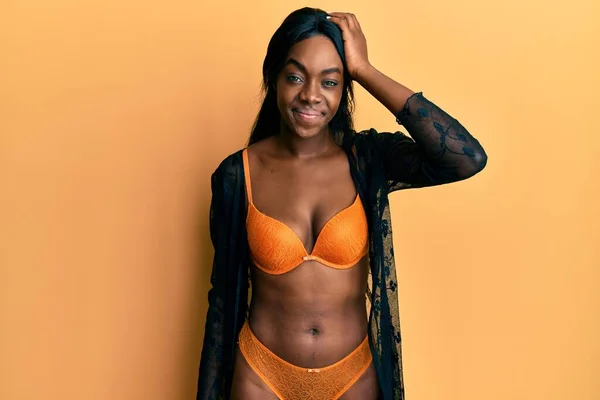 Young African American Woman Wearing Lingerie Confuse Wonder Question Uncertain — Stock Photo, Image