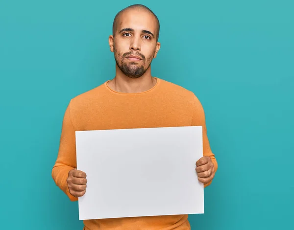 Hispanic Adult Man Holding Blank Empty Banner Thinking Attitude Sober — Stock Photo, Image