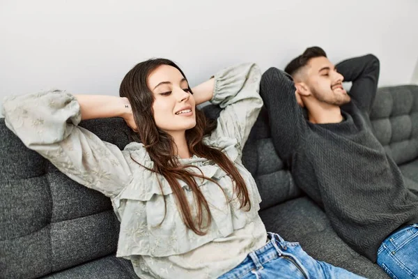 Young Hispanic Couple Resting Head Hands Sitting Sofa Home — Stock Photo, Image