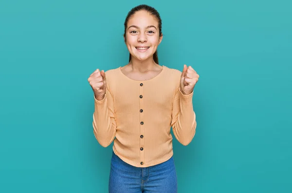 Beautiful Brunette Little Girl Wearing Casual Sweater Celebrating Surprised Amazed — Stock Photo, Image