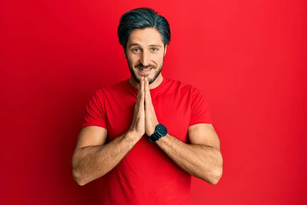 Young Hispanic Man Wearing Casual Red Shirt Praying Hands Together — Stock Photo, Image