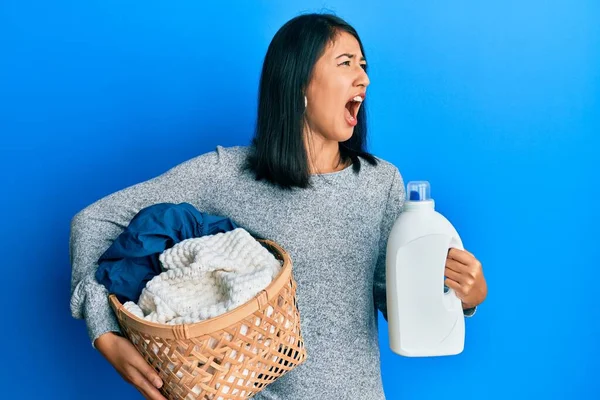 Beautiful Asian Young Woman Holding Laundry Basket Detergent Bottle Angry — Stock Photo, Image