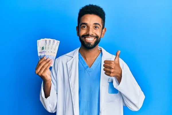 Hombre Hispano Guapo Con Barba Vistiendo Uniforme Médico Sosteniendo Pesos — Foto de Stock