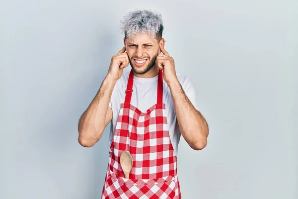 Young Hispanic Man Modern Dyed Hair Wearing Apron Covering Ears — Stock Photo, Image