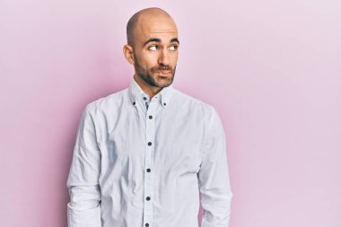 Gündelik kıyafetler giyen genç İspanyol adam gülümseyip yan tarafa bakıyor ve düşünüyor.. 