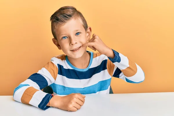 Förtjusande Kaukasiska Unge Klädd Avslappnade Kläder Sitter Bordet Leende Gör — Stockfoto