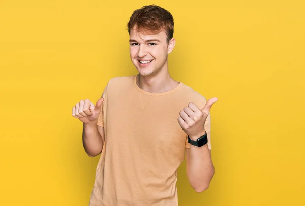 Young Caucasian Man Wearing Casual Clothes Pointing Back Hand Thumbs — Stock Photo, Image