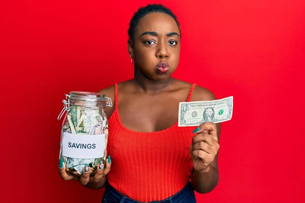 Mladá Afroameričanka Drží Sklenici Úsporami Dolarovou Bankovkou Legračním Obličejem Tvářích — Stock fotografie