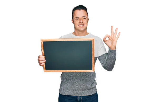 Handsome Young Man Holding Blackboard Doing Sign Fingers Smiling Friendly — Stock Photo, Image