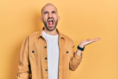 Avuç içleri açık genç bir adam elinde kızgın ve kızgın bir şey tutuyordu. Öfkeli ve öfkeliydi. Öfkeyle bağırıyordu.. 