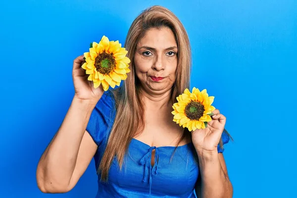 Middle Age Hispanic Woman Holding Yellow Sunflowers Skeptic Nervous Frowning — Stock Photo, Image