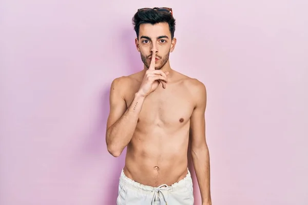 Young Hispanic Man Wearing Swimwear Shirtless Asking Quiet Finger Lips — Stock Photo, Image