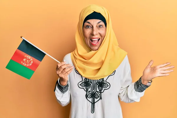 Middle Age Hispanic Woman Holding Afghanistan Flag Celebrating Achievement Happy — Stock Photo, Image