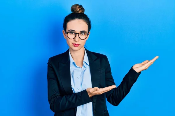 Young Hispanic Girl Presenting Open Palms Holding Something Relaxed Serious — Stock Photo, Image