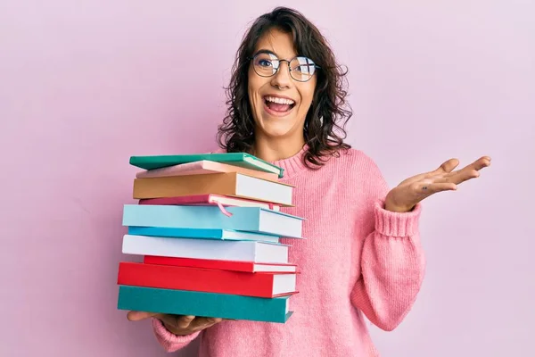 Young Hispanic Woman Holding Pile Books Celebrating Achievement Happy Smile — Stock Photo, Image