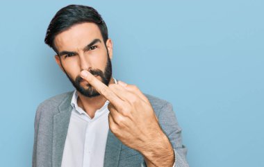 Young hispanic man wearing business clothes showing middle finger, impolite and rude fuck off expression 