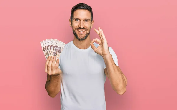Handsome Man Beard Holding Mexican Pesos Banknotes Doing Sign Fingers —  Fotos de Stock