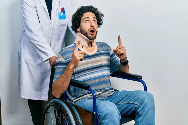 Handsome Hispanic Man Sitting Wheelchair Wearing Neck Collar Amazed Surprised — Stock Photo, Image
