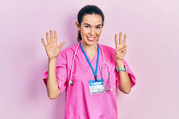 Doktor Üniforması Steteskop Giyen Genç Esmer Kadın Sekiz Numarayı Gösterip — Stok fotoğraf