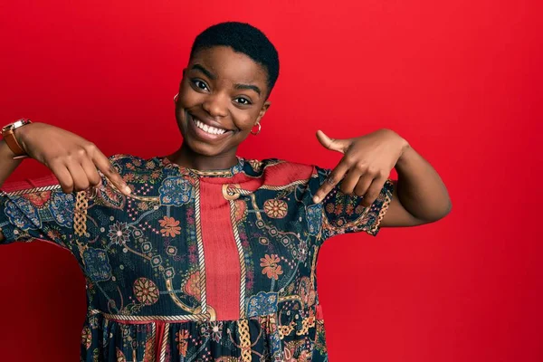 年轻的非洲裔美国女人穿着非洲风格的衣服 面带微笑 带着自信 用手指指着自己 自豪而快乐 — 图库照片