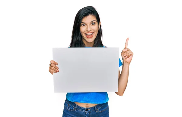 Young Hispanic Woman Holding Blank Empty Banner Surprised Idea Question — Stock Photo, Image