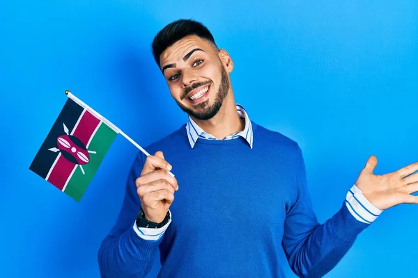 Mladý Hispánec Vousy Držící Keňskou Vlajku Slaví Úspěch Šťastným Úsměvem — Stock fotografie