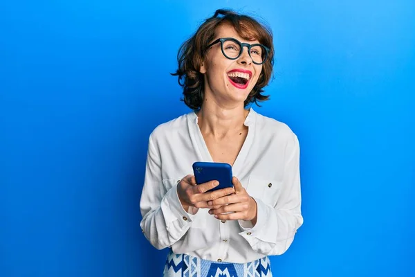 Junge Brünette Frau Mit Smartphone Lächelt Zur Seite Und Starrt — Stockfoto