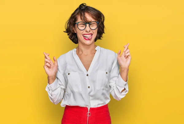 Young Hispanic Woman Wearing Business Style Glasses Gesturing Finger Crossed — Stock Photo, Image