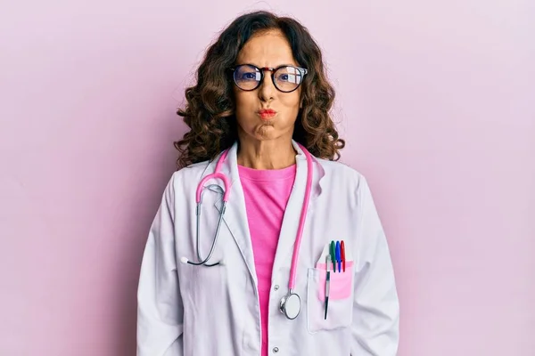 Middle Age Hispanic Woman Wearing Doctor Uniform Glasses Puffing Cheeks — Stock Photo, Image