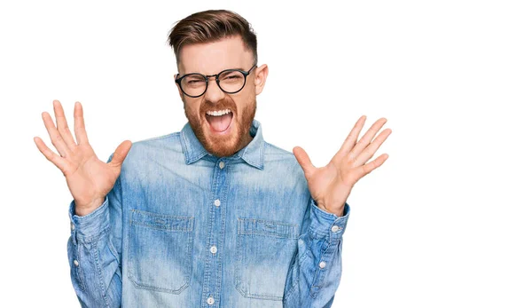 Young Redhead Man Wearing Casual Denim Shirt Celebrating Mad Crazy — Stock Photo, Image