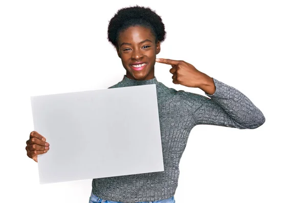 Young African American Girl Holding Blank Empty Banner Pointing Finger — Stock Photo, Image